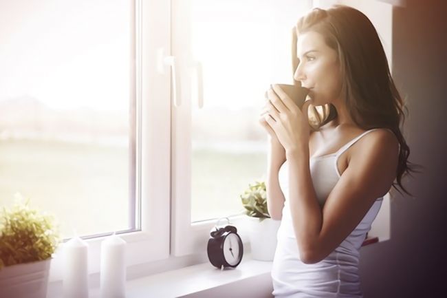 朝にコーヒーを飲む女性の画像